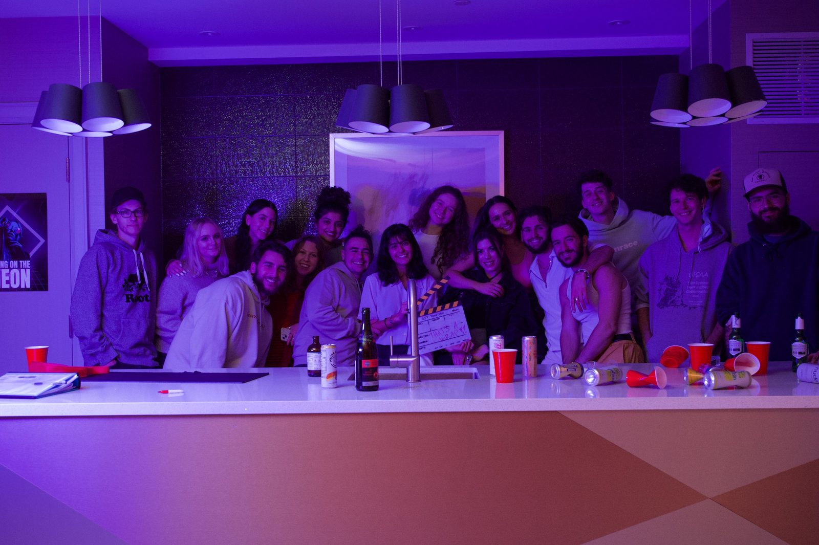 The full cast and crew holding the That's a wrap slate